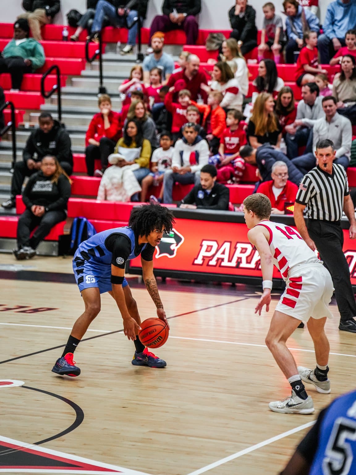 Owen, in the white number 14 jersey, cutting off a ball-handler during a live game
